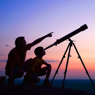 Adult and child using a telescope