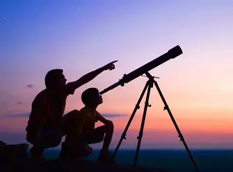 Adult and child using a telescope