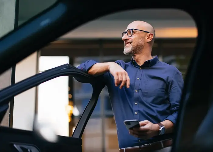 a man leaning on a car door
