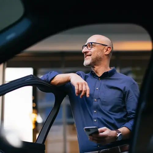 a man leaning on a car door