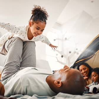 dad balancing daughter in the air like she's an airplane