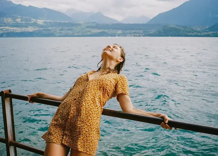 smiling woman leaning over a railing