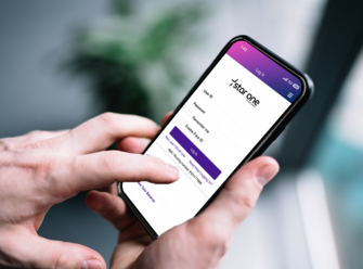 Hands holding mobile phone with Star One login page