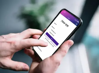 Hands holding mobile phone with Star One login page