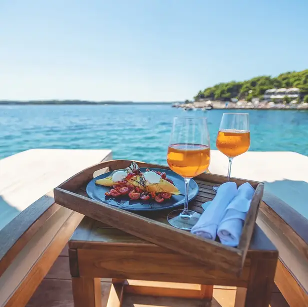 Wine glasses on table on boat in water