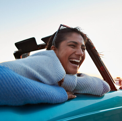 woman laughing in convertible