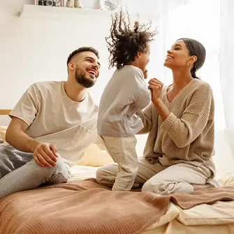 Family with child on bed