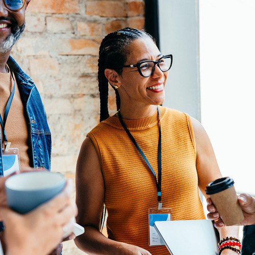 Group of business professionals enjoying a casual conversation with coffee stock