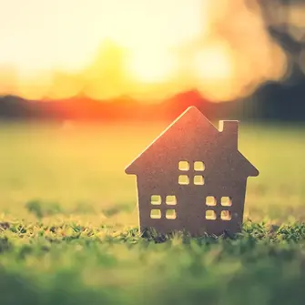 Silhouette of house on a lawn
