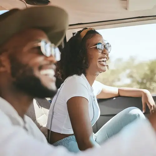 woman and man laughing in a car