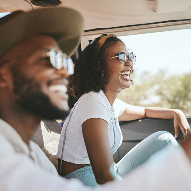 woman and man laughing in a car