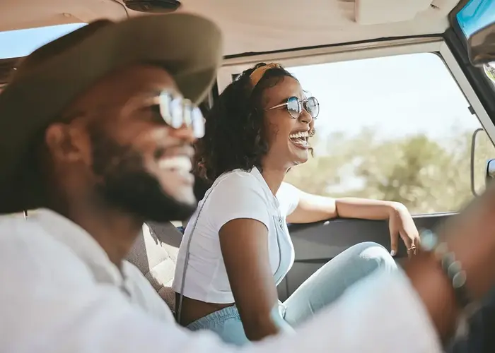 woman and man laughing in a car