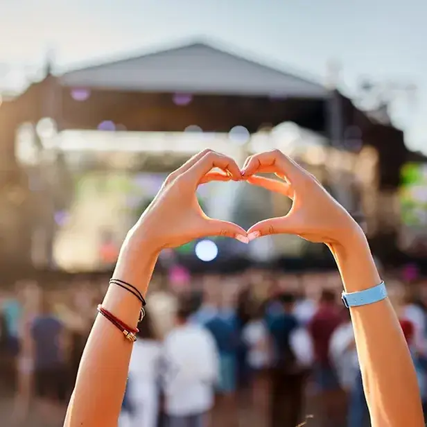 a person making a heart with their hands
